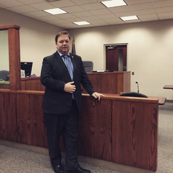 Image of a michigan wrongful death lawyer standing in his office.