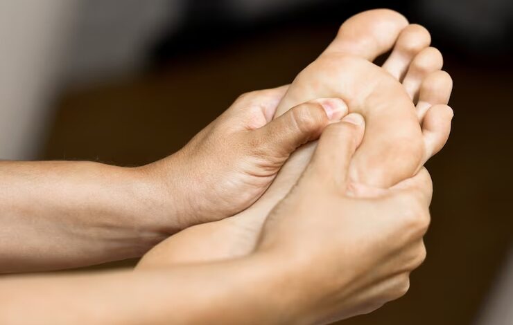 Medical massage at the foot in a physiotherapy center.