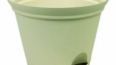 A green plastic planter featuring a secure lid, ideal for indoor or outdoor gardening.