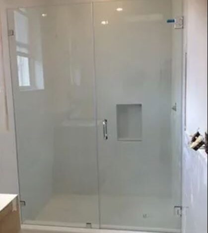 A sleek glass shower door in a modern bathroom, enhancing the space with transparency and elegance.